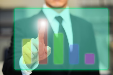 The business concept, business use fingers to control the level of the graph with the screen hologram