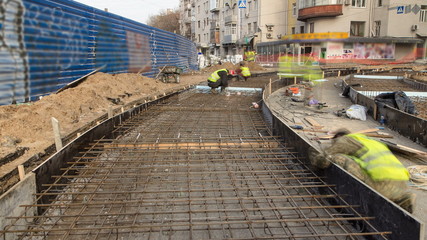 Workers with protective mask welding reinforcement for tram tracks in the city timelapse