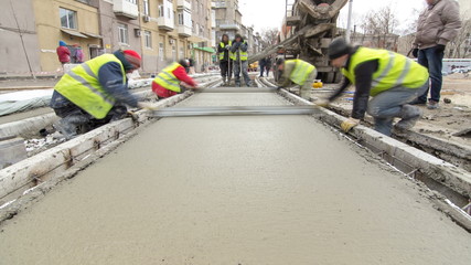 Pouring ready-mixed concrete after placing steel reinforcement to make the road by concrete mixer timelapse hyperlapse.