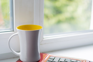 A cup of hot coffee on a laptop background.