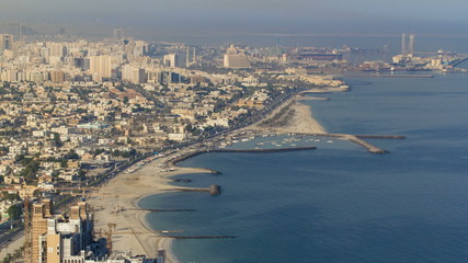 Panoramic view of Sharjah coastline from Ajman rooftop timelapse - third largest and most populous...