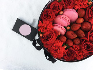 Flowers in a box and colorful almond cookies