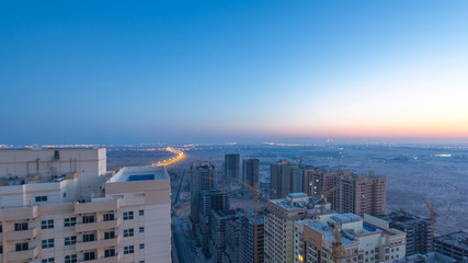 Cityscape of Ajman from rooftop night to day timelapse. Ajman is the capital of the emirate of Ajman in the United Arab Emirates.