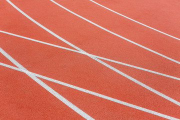 Fragment of a red treadmill with artificial cover, top view.