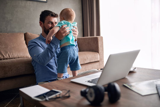 Man working from home and taking care of baby..