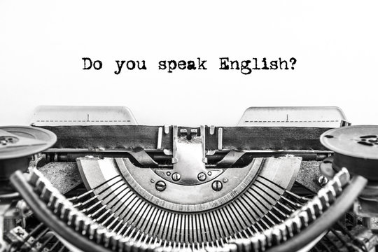 Do you speak English? typed text on a Vintage Typewriter, old paper, closeup. Education, training, school, foreign language