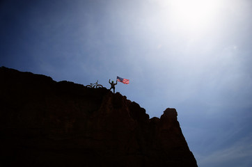 The cyclist with the victory to conquer the mountain, held the U.S. flag
