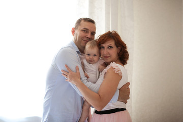 Fototapeta premium family with daughter toddler on hands in real