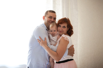 Fototapeta premium family with daughter toddler on hands in real