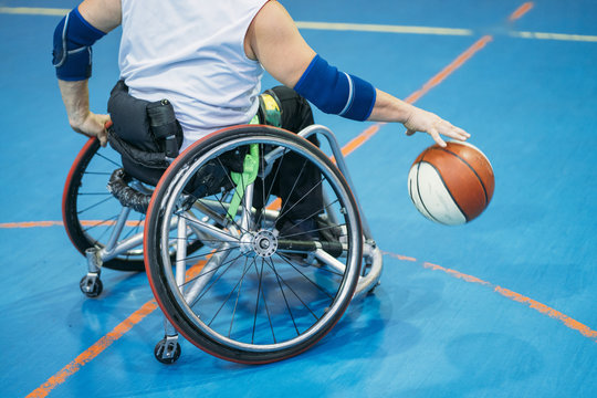 Disabled sport men in action while playing indoor basketball