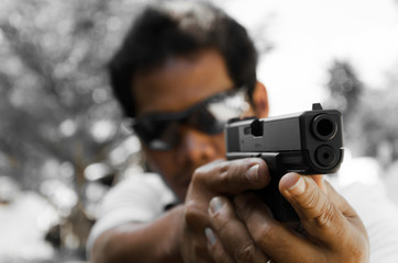 Close up black handgun holding in a man's hand