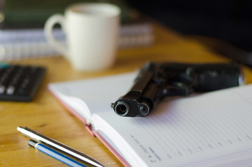 The gun on the desk of a businessman
