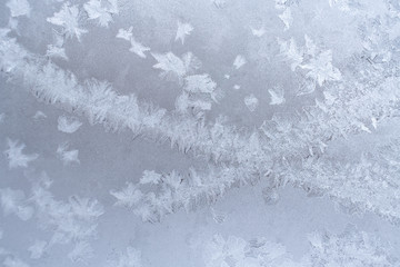 Openwork Christmas natural frosty pattern on winter window.