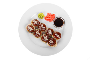 Sushi, rolls, uramaki, tempura, with teriyaki sauce, sesame, raw seafood, soy sauce, marinated ginger and wasabi, food on plate, white isolated background view from above. For the menu, restaurant
