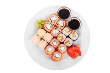 Set of sushi, rolls, uramaki, hosomaki, california, philadelphia, lava sauce, raw seafood, soy sauce, marinated ginger and wasabi food on plate, white isolated background view from above For the menu