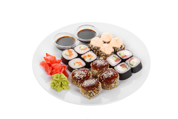 Set of sushi, rolls, uramaki, hosomaki, tempura, with teriyaki, lava sauce, raw seafood, soy sauce, marinated ginger and wasabi, food on plate, white isolated background Side view For the menu