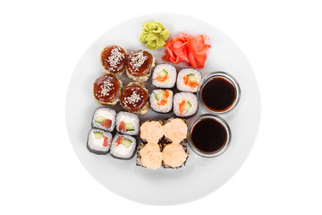 Set of sushi, rolls, uramaki, hosomaki, tempura, with teriyaki, lava sauce, raw seafood, soy sauce, marinated ginger and wasabi, food on plate, white isolated background view from above For the menu