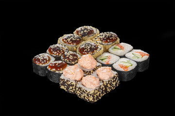 Set of sushi, rolls, uramaki, hosomaki, tempura, with teriyaki, lava sauce, raw seafood, soy sauce, marinated ginger and wasabi, black isolated background Side view For the menu, restaurant bar cafe