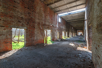 The interior of the destroyed brick building of abandoned collective farm in Russia