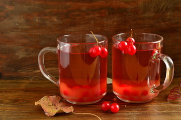 Red hot tea with viburnum berries in a glass cup