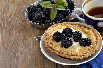 Tartlets with cream and blackberries, copy space