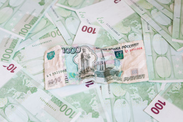 Obraz na płótnie Canvas Crumpled banknote of one thousand rubles against the background of hundreds euro banknotes