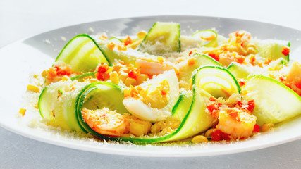 salad of young corn, cucumber slices, egg, fried in garlic oil and chili shrimps sprinkled with lemon juice