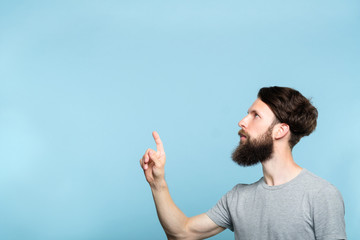 thoughtful man reaching and wanting to press virtual button on the left. free space for...