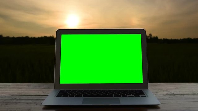 Laptop green screen with sunset
