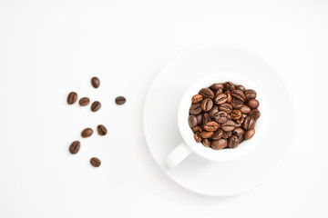 coffee cup full of roasted coffee beans
