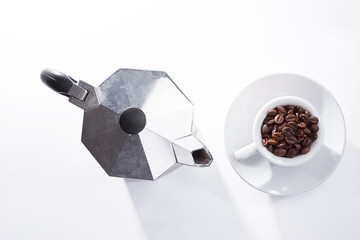 Coffee pot and roasted coffee beans into the cup
