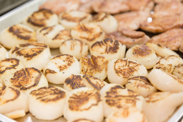 A plate of Chicken pieces cooked in a pan in a restaurant kitchen.