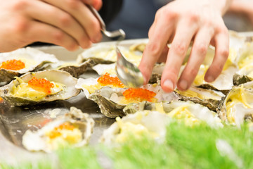A plate of Oysters in a restaurant kitchen with Caviar filling.