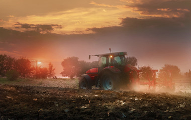 Farmer plowing stubble field