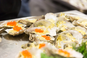 A plate of Oysters in a restaurant kitchen with Caviar filling.