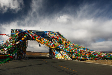 Dramatic sky over the prayer flag-covered Gyatso La pass, the highest point on the Friendship...