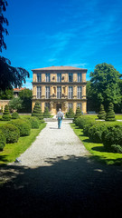 Fototapeta premium An older man walking in a landscaped garden in Southern France.