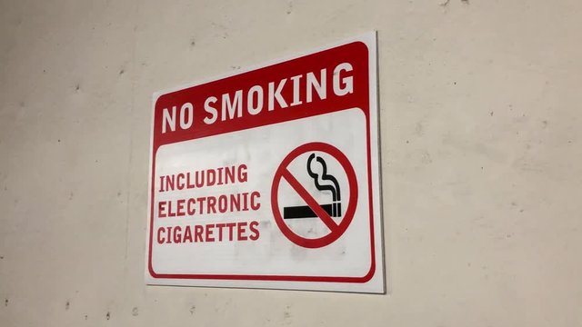 Motion of no smoking area including electronic cigarettes sign on wall with 4k resolution