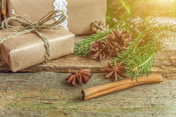 Christmas New Year composition with gift box fir branch pine cones cinnamon sticks on old shabby rustic wooden background. Xmas holiday december decoration to Russian tradition. Flat lay, copy space