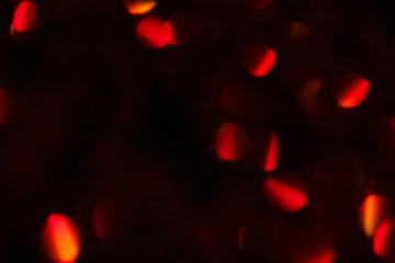 abstract lens flare on black background. red defocused lights. glowing blurred color burst. festive new year backdrop.