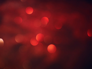 Christmas Red Blurred background lights. New Year background. Abstract defocused gold, white, red and yellow glitters texture. Shining glowing effects