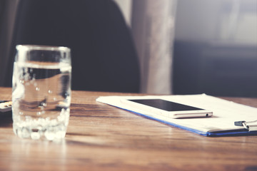 Fototapeta premium phone on document with water on table