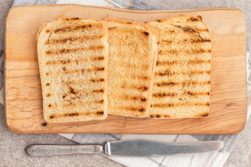 Crispy toasts for breakfast with knife and napkin