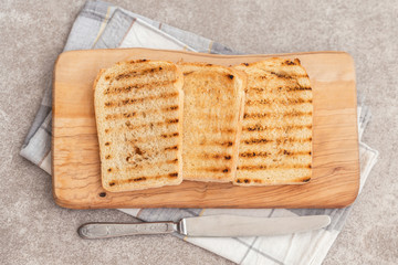 Crispy toasts for breakfast with knife and napkin