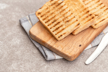 Crispy toasts for breakfast with knife and napkin