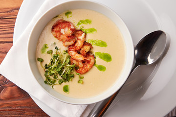 Creamy cheese soup with grilled shrimps