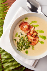 Creamy cheese soup with grilled shrimps