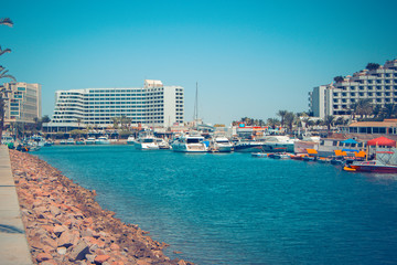 Panorama of Eilat attractions with watercraft and five-star hotels
