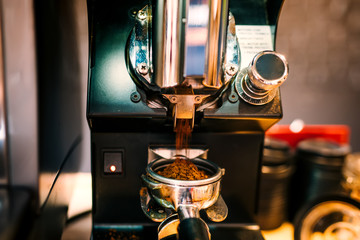 coffee grinder grinding fresh beans, preparing espresso