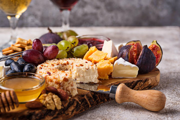 Cheese plate with grapes and wine